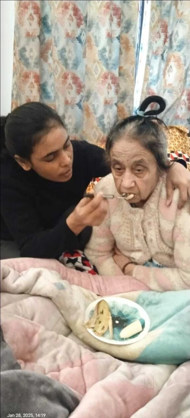 CareOn24 nurse helping elderly lady